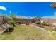A well-maintained backyard featuring a lawn, a swing bench, a barbecue grill, a table and some landscaping at 10755 W Mountain View Dr, Avondale, AZ 85323