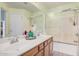 Bathroom with a double sink vanity, a large mirror, and a shower and tub combination at 10755 W Mountain View Dr, Avondale, AZ 85323