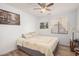 Bedroom with a double bed, bedside table, window, and a painting on the wall at 10755 W Mountain View Dr, Avondale, AZ 85323