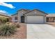 Charming single-story home featuring a well-manicured front yard and a two-car garage at 10755 W Mountain View Dr, Avondale, AZ 85323