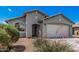 Charming home featuring manicured front yard, desert landscaping, and a two-car garage at 10755 W Mountain View Dr, Avondale, AZ 85323