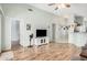 Spacious living room with laminate floors, ceiling fan, and neutral paint at 10755 W Mountain View Dr, Avondale, AZ 85323