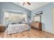 Inviting main bedroom with laminate floors, ceiling fan, and large windows at 10755 W Mountain View Dr, Avondale, AZ 85323