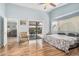 Spacious main bedroom featuring laminate floors, neutral paint, ceiling fan, and backyard access at 10755 W Mountain View Dr, Avondale, AZ 85323