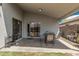 Covered patio with seating and a view of the well-kept backyard at 10755 W Mountain View Dr, Avondale, AZ 85323