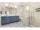 Bright bathroom with double vanity, tub, marble floors and shower, offering a clean and stylish design at 1162 S Agnes Ln, Gilbert, AZ 85296
