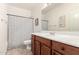 Traditional bathroom featuring a wood vanity, large mirror, and a shower with a striped curtain at 1162 S Agnes Ln, Gilbert, AZ 85296