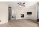 Bedroom with hardwood floors, ceiling fan, electric fireplace, and ensuite bathroom at 1162 S Agnes Ln, Gilbert, AZ 85296