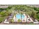 Gorgeous aerial view of a refreshing community pool surrounded by lush palm trees and lounge chairs at 1162 S Agnes Ln, Gilbert, AZ 85296