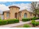 Charming stucco home featuring a turret entrance, tile roof, and manicured landscaping at 1162 S Agnes Ln, Gilbert, AZ 85296