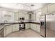 Well-lit kitchen with sage-colored cabinetry, tile flooring, and stainless steel appliances at 1162 S Agnes Ln, Gilbert, AZ 85296
