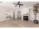Spacious living area with hardwood floors, fireplace, and arched doorways at 1162 S Agnes Ln, Gilbert, AZ 85296