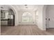 Bright living room with an arched window, hardwood floors, and stainless steel appliances at 1162 S Agnes Ln, Gilbert, AZ 85296