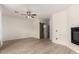 Bright living room with vinyl floors, a ceiling fan, a fireplace, and sliding barn door that leads to the bathroom at 1162 S Agnes Ln, Gilbert, AZ 85296