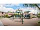 Community playground with climbing structure, shade canopies, and seating areas at 1162 S Agnes Ln, Gilbert, AZ 85296