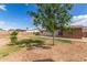 Vast backyard featuring a mix of grassy areas, mature trees, and a cozy outdoor space for relaxation at 126 E Mclellan Rd, Mesa, AZ 85201