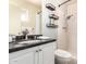 Modern bathroom with granite counters, shelves, and shower over tub providing a refreshing space for daily routines at 126 E Mclellan Rd, Mesa, AZ 85201