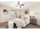 Cozy bedroom with a ceiling fan, neutral paint, and abundant natural light offers a serene retreat within the home at 126 E Mclellan Rd, Mesa, AZ 85201