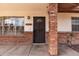 Close-up of the front door, brick columns, and sidelight windows creating a charming entryway at 126 E Mclellan Rd, Mesa, AZ 85201