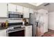 Galley kitchen boasts white cabinetry, stainless steel appliances, and stylish granite countertops, ready for culinary adventures at 126 E Mclellan Rd, Mesa, AZ 85201