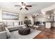 Comfortable living room featuring a cozy sectional sofa, decorative ottoman, and tile flooring at 126 E Mclellan Rd, Mesa, AZ 85201