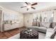 Bright living room featuring a sectional, decorative accents, ceiling fan, and tile flooring at 126 E Mclellan Rd, Mesa, AZ 85201
