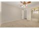 Bedroom with ceiling fan and sliding mirror door at 1332 E Redfield Rd, Tempe, AZ 85283