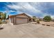 Spacious driveway leading to a two-car garage, complemented by desert landscaping and ample parking space at 1332 E Redfield Rd, Tempe, AZ 85283