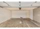 Open garage with ample space, white walls, brick accents, and overhead lighting at 1332 E Redfield Rd, Tempe, AZ 85283