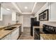 Modern kitchen with stainless steel appliances, granite countertops, and white cabinetry, offering ample storage at 1332 E Redfield Rd, Tempe, AZ 85283