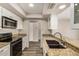 Modern kitchen featuring granite countertops, stainless steel appliances and white cabinets at 1332 E Redfield Rd, Tempe, AZ 85283
