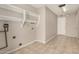 Spacious laundry room features tiled floors, built-in shelving, and utility hookups at 1332 E Redfield Rd, Tempe, AZ 85283