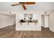 Open living space featuring new laminate flooring, a breakfast bar, and seamless flow into the kitchen at 1332 E Redfield Rd, Tempe, AZ 85283