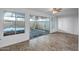 Bedroom featuring tile flooring, large windows, and a sliding glass door at 13424 N Emberwood Dr, Sun City, AZ 85351