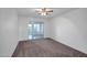Bedroom featuring neutral carpet, white walls, and a sliding glass door to patio at 13424 N Emberwood Dr, Sun City, AZ 85351