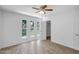 Bedroom featuring tile flooring, closet, and large windows with natural light at 13424 N Emberwood Dr, Sun City, AZ 85351