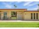 Charming front exterior with well-manicured lawn, mature trees, and lush landscaping at 13424 N Emberwood Dr, Sun City, AZ 85351
