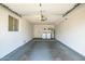 Attached garage with painted concrete floor, window, washer and dryer, and water heater at 13424 N Emberwood Dr, Sun City, AZ 85351