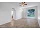 Living room featuring tile flooring, ceiling fan, and large windows at 13424 N Emberwood Dr, Sun City, AZ 85351