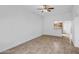 Living room featuring tile flooring, ceiling fan, and view into the kitchen at 13424 N Emberwood Dr, Sun City, AZ 85351
