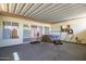 Covered patio featuring a spa and sliding glass door to the interior of the home at 13424 N Emberwood Dr, Sun City, AZ 85351
