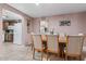 Cozy dining room area with a dining table set for eight and view of the kitchen with white appliances at 13608 N 33Rd Ave, Phoenix, AZ 85029