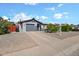 Charming single-story home featuring a gray exterior, well-maintained landscaping, and a two-car garage at 13608 N 33Rd Ave, Phoenix, AZ 85029