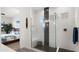 Modern bathroom featuring a glass-enclosed shower with black tile accents and decorative floor tile at 14587 W Alexandria Way, Surprise, AZ 85379
