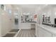 Elegant bathroom with patterned floor, a walk-in shower, and dual vanities, offering luxury and comfort at 14587 W Alexandria Way, Surprise, AZ 85379