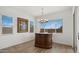 Chic dining area featuring a modern chandelier and a vintage-style bar area with ample natural light at 14587 W Alexandria Way, Surprise, AZ 85379