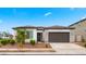 Beautiful single-story home featuring a two-car garage and nicely landscaped front yard at 14587 W Alexandria Way, Surprise, AZ 85379