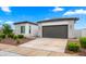 A well-maintained home showing a two-car garage and a neatly landscaped yard at 14587 W Alexandria Way, Surprise, AZ 85379