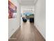 Open hallway view with decorative art and a view into the living area at 14587 W Alexandria Way, Surprise, AZ 85379