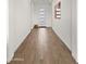 The bright hallway features wood-look tile flooring and a modern front door at 14587 W Alexandria Way, Surprise, AZ 85379